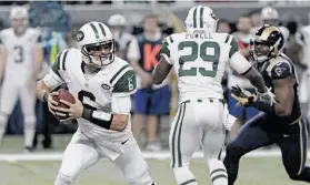  ?? Seth Perlman / Associated Press ?? Jets quarterbac­k Mark Sanchez had a turnover-free game as his team emerged from an offensive funk to top the Rams 27-13, without help from Tim Tebow.