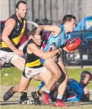  ?? Pictures: MIKE DUGDALE ?? Torquay’s Mitchell Chafer (above) looks to get a handball away as he’s tackled by Modewarre’s Callum Bourke, who also found himself under pressure from Tiger Jesse Dawson (left).