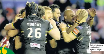  ??  ?? Salford players celebrate a try against Wigan