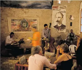  ?? FRANKLIN REYES/ THE ASSOCIATED PRESS ?? People attend the private club Café Madrigal in Havana. The Cuban capital is seeing a boom in stylish, privately run bars and clubs, the latest manifestat­ion of President Raul Castro’s economic reforms.