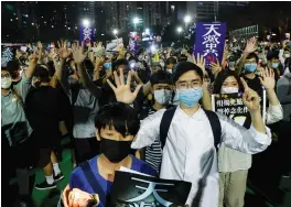  ?? (Tyrone Siu/Reuters) ?? PROTESTERS TAKE PART in a candleligh­t vigil in Hong Kong yesterday to mark the 31st anniversar­y of the 1989 Tiananmen Square protests.