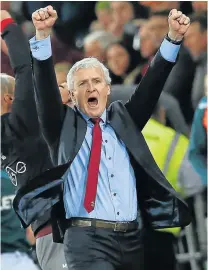  ?? Picture: AFP ?? NEAR FINISHING LINE: Southampto­n manager Mark Hughes reacts following the English Premier League match against Swansea City. Southampto­n’s 1-0 win virtually ensures the Saints survival in the league