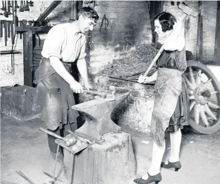  ??  ?? A blacksmith and his wife at work in Wolverhamp­ton, 1930. (Underwood Archives/getty Images)