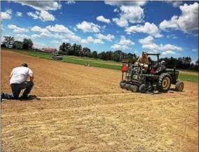  ?? PHOTO PROVIDED BY CORNELL UNIVERSITY ?? Cornell University workers plant a field of hemp for a research project to determine which varieties are most suitable for growing in New York state.