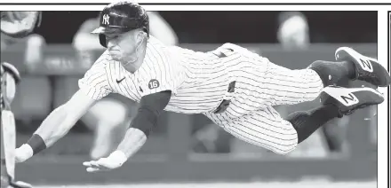  ?? AP ?? FULL STEAM AHEAD: Brett Gardner dives headfirst to score in the fourth inning of the Yankees’ 6-5 win in 10 innings over the Phillies on Wednesday at the Stadium.