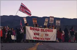  ?? CALEB JONES — THE ASSOCIATED PRESS ?? Demonstrat­ors block a road at the base of Hawaii’s tallest mountain Monday in Mauna Kea to protest the constructi­on of a giant telescope on land that some Native Hawaiians consider sacred.
