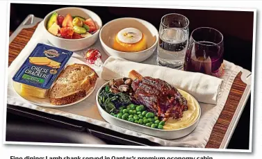  ?? ?? Fine dining: Lamb shank served in Qantas’s premium economy cabin