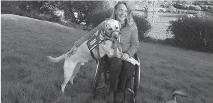  ?? Courtesy of Chris Slavin/TNS ?? LEFT:
Chris Slavin of Danvers, Mass., with her 3-year-old service dog Earle. Massachuse­tts is considerin­g a bill that would crack down on people who misreprese­nt their pets as service dogs. Nineteen other states have adopted similar measures.