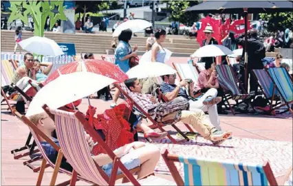  ??  ?? Lazy lunch: City dwellers lounge in deck chairs in Aotea Square and listen to some live music during Live at Lunch.