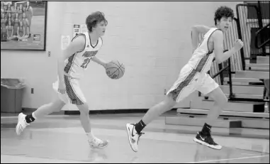  ?? Photo by Gerren Smith ?? PANTHER TRANSITION: Magnet Cove’s Levi Horton (22) dribbles the ball to lead the transition with Owen Tillery (11) during senior high boys hoops at Magnet Cove High School Gymnasium.