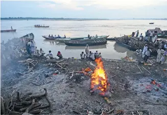  ??  ?? Cremations at Manikarnik­a Ghat