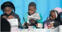  ?? Picture: Daniel Born ?? Children cut out a Nal’ibali booklet at the Ikageng Library in Orlando West in Soweto.