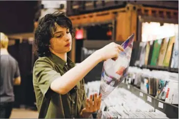  ?? YORK TIMES GEORGE ETHEREDGE/THE NEW ?? Finn Wolfhard searches for records at Rough Trade NYC in New York, on July 31.