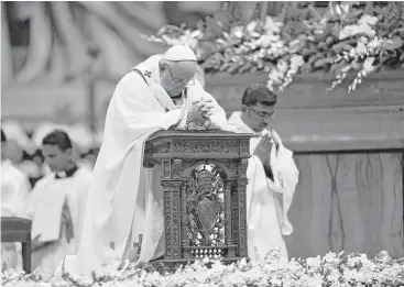  ??  ?? Pope Francis prays during Christmas Eve Mass in St. Peter’s Basilica at the Vatican. Celebratin­g the birth of Jesus, Francis spent much of the service bemoaning the plight of children in war-torn countries. A native of Argentina, the pope marked his...