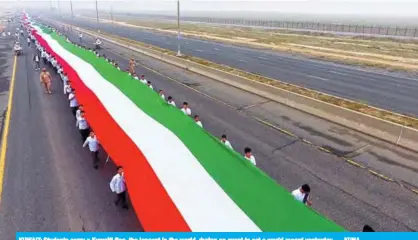  ??  ?? KUWAIT: Students carry a Kuwaiti flag, the longest in the world, during an event to set a world record yesterday. — KUNA