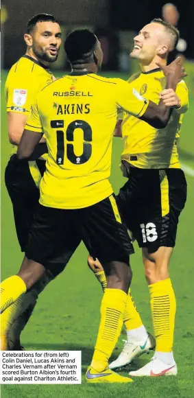  ??  ?? Celebratio­ns for (from left) Colin Daniel, Lucas Akins and Charles Vernam after Vernam scored Burton Albion’s fourth goal against Charlton Athletic.