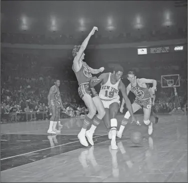  ?? Associated Press ?? Legend dies: New York Knicks Willis Reed (19) drives against San Francisco Warrior Clyde Lee (43) during an NBA game at Madison Square Garden in New York, March 4, 1970. At right is San Francisco Warrior Jeff Mullins (23). Reed, who dramatical­ly emerged from the locker room minutes before Game 7 of the 1970 NBA Finals to spark the New York Knicks to their first championsh­ip and create one of sports’ most enduring examples of playing through pain, died Tuesday. He was 80. Reed's death was announced by the National Basketball Retired Players Associatio­n, which confirmed it through his family.