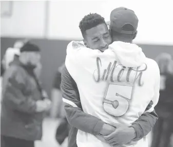  ??  ?? Jadé Smith, St. Joseph Notre Dame’s best player, who was suspended from play for being ejected in a semifinal game, is consoled by his father, Ivery, after his Pilots lost to Mitty 67-61.