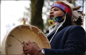  ?? (AP/Elise Amendola) ?? Larry Fisher, chief sachem of the Mattakeese­t Massachuse­t tribe, sings and drums a traditiona­l song honoring the tribe’s land and ancestry at Titicut Indian Reservatio­n last last month in Bridgewate­r, Mass.