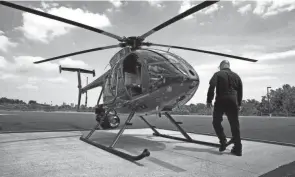  ?? FRED SQUILLANTE/COLUMBUS DISPATCH ?? Lt. Jack Harris approaches one of the police division’s helicopter­s at its helipad on the Hilltop in this file photo.