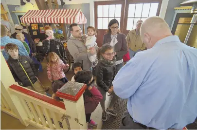  ?? HERALD PHOTOS BY JOSEPH PREZIOSO ?? ‘AN ICON FOR THE COMMUNITY’: Jim Callahan, director of operations, rips ticket stubs at the gate entry at the 2018 season grand opening of the 90-year-old Paragon Carousel.