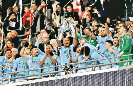  ??  ?? Manchester City skipper Vicente Kompany lifts the League Cup in London on Sunday