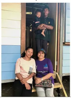  ??  ?? Dream come true: Shanti (in purple shirt), Anis (left), Azrul and his daughter Uli Yana at the entrance of their newly built house at Kampung Orang Asli Sungai Lalang.