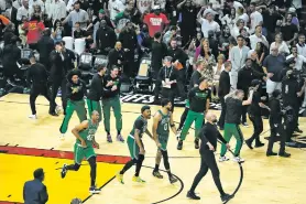 ?? REBECCA BLACKWELL/THE ASSOCIATED PRESS ?? Boston players celebrate after a game-winning putback tied their Eastern Conference finals series against the Heat on Saturday in Miami. The Celtics once trailed 0-3.