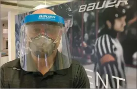  ?? The Canadian Press ?? A man wears a protective mask in a handout photo. Canadian hockey equipment manufactur­er Bauer is offering to modify its production line to make protective visors for doctors, nurses and first responders.