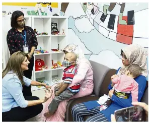  ?? — NCSM ?? Princess Dina talking to young cancer patients and their mothers at the National Cancer Society of Malaysia.