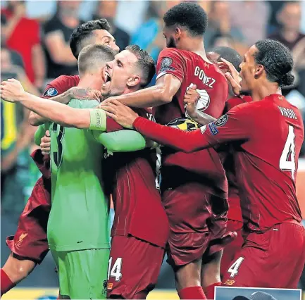  ??  ?? Adrian is mobbed by Liverpool team-mates after his vital penalty save.