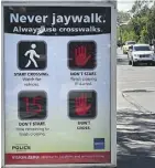  ?? ED KAISER ?? An anti-jaywalking sign was installed on Whyte Avenue near 101 Street. Two people were killed at this location while crossing the road legally.