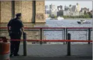  ?? AP PHOTO/ROBERT BUMSTED ?? A New York Police Department officer stands guard as authoritie­s investigat­e the death of a baby boy who was found floating in the water near the Brooklyn Bridge in Manhattan on Sunday.