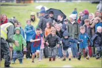  ?? f31 Arisaig Games Junior boys race 8JP ?? Determinat­ion on the faces of runners as the junior boys’ race gets under way.