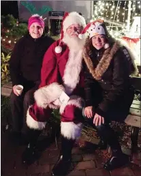  ?? SUBMITTED PHOTO ?? Beth Harmer, left, vice president of Lansdowne Business and Profession­al Associatio­n, and Andrea DiFabio, right, LBPA board member, visit with Billy O’ Doherty, “Santa,” for the group’s annual winter social.