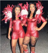  ??  ?? Smirnoff ladies in red, Shenoya Lewis and Tajaeda Gayle (right) are in high spirits for soca activities.