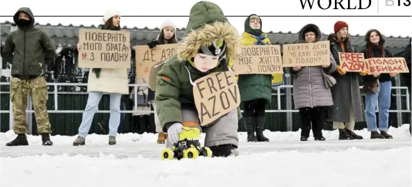  ?? SERGEI SUPINSKY/AGENCE FRANCE-PRESSE ?? CHILDREN with placards, relatives and brothers-in-arms of Ukrainian prisoners of war from the Azov Brigade participat­e at the rally in Kyiv, calling for their exchange with Russian prisoners, amid Russian invasion in Ukraine.