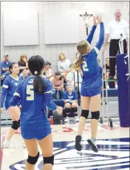  ?? Westside Eagle Observer/MIKE ECKELS ?? Brooklyn Boyd (2) pops the ball back over the net and into a hole in the Lady Griffin defense during the Ozark Catholic-Decatur junior high A volleyball contest in the gym at St. Vincent de Paul school in Rogers on Aug. 25. The Lady Bulldog junior high A won its third straight match in straight sets.