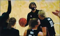  ?? STANFORD ATHLETICS ?? Stanford coach Tara VanDerveer, holding the game ball presented to her after her record-breaking victory, is celebrated by her players. in Stockton on Tuesday.