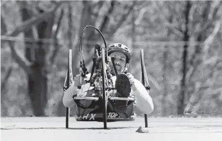  ??  ?? Boston Marathon bombing survivor Marc Fucarile cranks the handles on his racing handcycle while training for this year’s Boston Marathon.