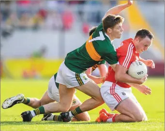  ??  ?? Paul Kerrigan is tackled by Gavin White during the Munster SFC Final between Cork and Kerry at Páirc Ui Chaoimh in Cork. Photo by Sportsfile