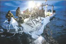  ?? U.S. NAVY VIA AP ?? This image provided by the U.S. Navy shows sailors assigned to Explosive Ordnance Disposal Group 2 recovering a high-altitude surveillan­ce balloon off the coast of Myrtle Beach, S.C., on Feb. 5.