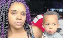  ?? [PHOTO BY
ROBERT MEDLEY, THE OKLAHOMAN] ?? Takia Harding holds her son, Tyree Polite, 2, whom she dropped from a second-floor apartment to be rescued from a fire. Tyree was caught by Oklahoma City police officer Anthony Glover.