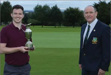  ??  ?? Friends of Baltinglas­s winner John Kelly Jnr accepts the Claret Jug from Baltinglas­s Golf Club captain Liam Horgan last weekend.
