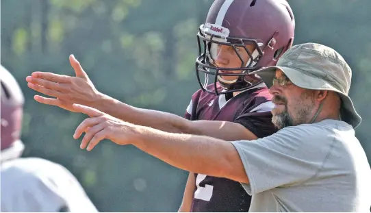  ?? STAFF FILE PHOTO BY CHRIS CHRISTO ?? LOSING SCORE: Millis football coach Dana Olson, right, has seen the number of players on his team dwindle down to 28 for this season, having lost seven to golf alone.