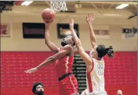  ??  ?? Homewood-Flossmoor’s Christian Meeks, left, goes for a layup against Bolingbroo­k’s Donaven Younger.