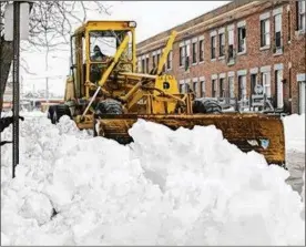  ?? KUNTZ / THE PLAIN DEALER ?? A city of Cleveland plow clears the snow down East 76th Street near the intersecti­on of St. Clair Avenue on March 10, 2008.JOHN