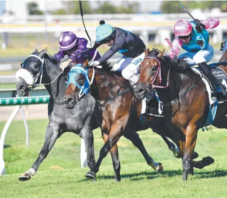  ?? Picture: AAP IMAGE/DARREN ENGLAND ?? Jockey Ron Stewart (second from left) rides Boomtown Lass to victory at Doomben on Saturday