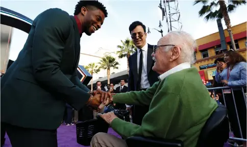  ??  ?? ACTOR CHADWICK Boseman (left) shakes hands with comic book legend Stan Lee.