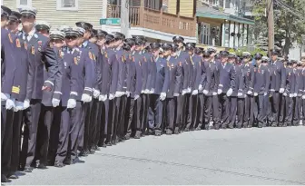  ??  ?? SAYING GOODBYE: Firefighte­rs, above, line up in formation yesterday before the funeral Mass for Boston firefighte­r Justin Poitras at St. Rita Church in Lowell, top.